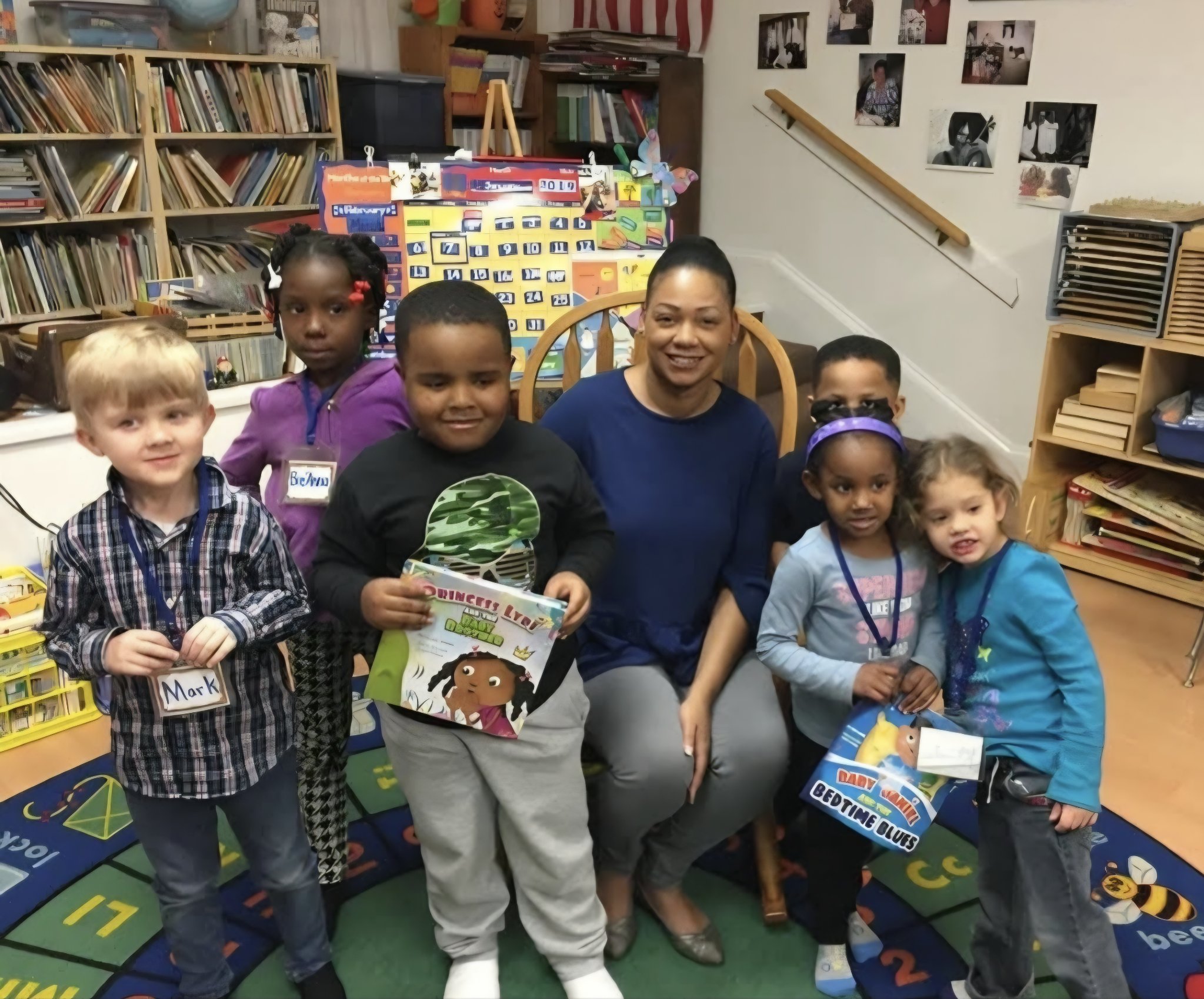 Children in a classroom holding bulk-ordered Find the Light Books picture books with their teacher